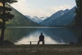 Senior is seating alone on the beach bench in overcast weather Royalty Free Stock Photo