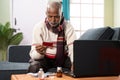 Senior sick old man entering card details for buying medicines online - concept of online medicine shopping