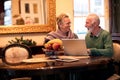 Senior smiling happy couple using computer at home Royalty Free Stock Photo