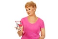 Senior smiling woman holding small trolley Royalty Free Stock Photo