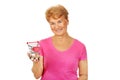 Senior smiling woman holding small trolley Royalty Free Stock Photo