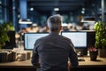 Senior software developer works on his personal computer in office environment