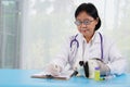 Senior specialist veterinary taking note of present illness rabbit to treatment at veterinary clinic, selective focus at vet