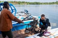 Senior sports instructor teaching man with disability wakeboarding lesson