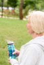 senior sporty woman holding sport bottle with water