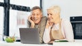 Senior Spouses Sitting At Laptop In Modern Kitchen At Home Royalty Free Stock Photo