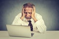 Senior stressed man working on laptop sitting at table Royalty Free Stock Photo