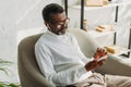 Senior, stylish african american man listening music in headphones