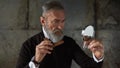 Senior stylish man combing his beard with comb