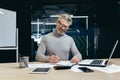 Senior successful businessman and investor working on paper work in the office, mature gray haired male boss working Royalty Free Stock Photo