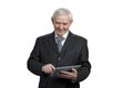 Senior in suit swiping tablet. Royalty Free Stock Photo