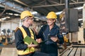 senior supervisor male talking with young new engineer employee training teaching for machine operate Royalty Free Stock Photo