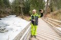 Senior taking a selfie near frozen river Royalty Free Stock Photo