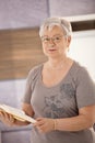 Senior teacher holding textbook