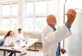 Senior teacher teaching biology to high school students in labor Royalty Free Stock Photo