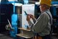 Senior Technician with Digital Tablet