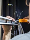 Senior technician installing network cables in data rack cabinet Royalty Free Stock Photo