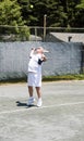 Senior tennis player serving ball Royalty Free Stock Photo