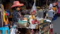 Senior Thai woman selling freshly cooked street food in Wang Lang Market