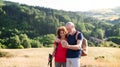 Senior tourist couple hikers standing in nature, taking selfie.