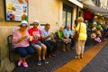 Senior tourists resting on chairs and enjoying a cold ice cream, Bardolino Italy