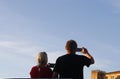 Senior tourists taking photographs in mallorca streets