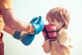 Senior trainer and little boy wearing boxing gloves. Portrait of a determined senior boxer with little boy child over Royalty Free Stock Photo