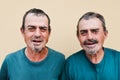 Senior twin men smiling on camera - Focus on faces