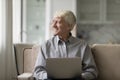Senior man use modern laptop seated on sofa at home Royalty Free Stock Photo