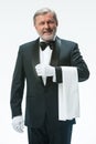 Senior waiter holding white towel