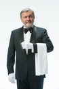 Senior waiter holding white towel