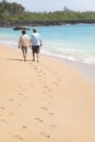 Senior walking on the beach with footprint Royalty Free Stock Photo