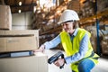 Senior warehouse woman worker working with barcode scanner. Royalty Free Stock Photo