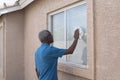 Senior washing a home window
