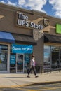 Senior wearing face mask retail strip mall UPS store