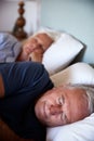 Senior white couple asleep in their bed, close up, vertical Royalty Free Stock Photo