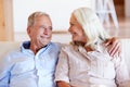 Senior white couple relaxing at home, looking at each other smiling, front view, close up Royalty Free Stock Photo