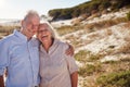 Senior white couple standing on a beach embracing and smiling to camera, close up Royalty Free Stock Photo