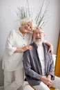 senior caucasian wife and husband posing at camera smiling on cozy couch at home Royalty Free Stock Photo