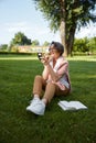 Senior woman applying lipstick doing makeup for charming smile Royalty Free Stock Photo