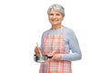 senior woman in apron with pot cooking food Royalty Free Stock Photo