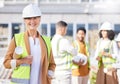 Senior woman, architect and blueprint, inspection at construction site with maintenance, contractor and smile in Royalty Free Stock Photo