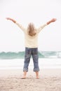 Senior Woman With Arms Outstretched On Beach Royalty Free Stock Photo