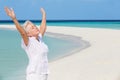 Senior Woman With Arms Outstretched On Beautiful Beach Royalty Free Stock Photo