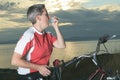 Senior woman with asthma inhalator on bike at the