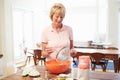 Senior Woman Baking In Kitchen Royalty Free Stock Photo