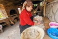 Senior woman baking pies in her home kitchen in Georgian village style with stone oven Royalty Free Stock Photo