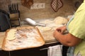 Senior woman baking pies in her home kitchen.Grandma cooks pies. Home cooked food. omemade mold cakes of the dough in Royalty Free Stock Photo