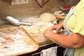 Senior woman baking pies in her home kitchen.Grandma cooks pies. Home cooked food. omemade mold cakes of the dough in Royalty Free Stock Photo