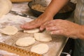 Senior woman baking pies in her home kitchen.Grandma cooks pies. Home cooked food. omemade mold cakes of the dough in Royalty Free Stock Photo